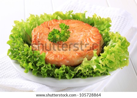 Pan seared fish cake served on lettuce