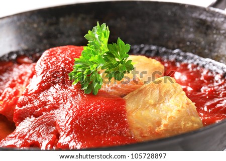 Pan fried fish fillets in rich tomato sauce