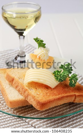 Two pieces of crispy toast, butter and boiled egg