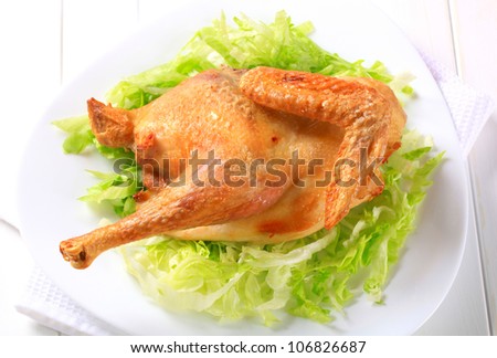 Roasted half chicken on nest of shredded lettuce