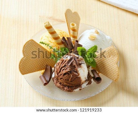 Scoops of ice cream decorated with wafers and chocolate curls