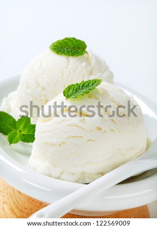 Two scoops of white ice cream - lemon, vanilla or coconut flavor