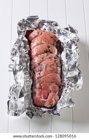 Thyme beef tenderloin in aluminum foil