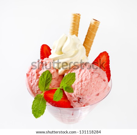 top of ice cream sundae with whipped cream and biscuit sticks