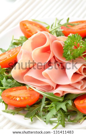 garden salad with fresh ham, arugula and cherry tomatoes