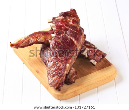 baked pork ribs on the wooden cutting board