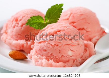 three strawberry ice cream scoop with almond and mint