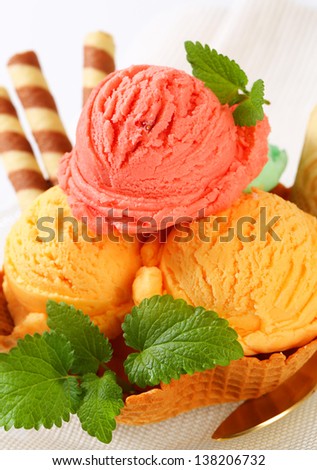 ice cream sundae with vanilla and strawberry ice cream and biscuit sticks