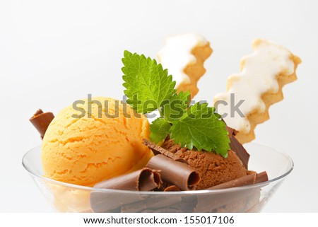 sundae consists of chocolate and vanilla ice cram and chocolate curls