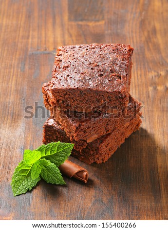 three pieces of chocolate cake with mint and chocolate curl
