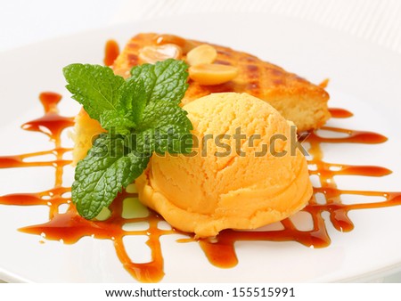 detail of butter cake with scoop of ice cream and caramel sauce
