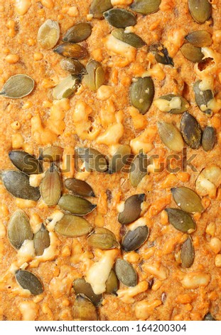 detail of crispy bread with seeds and melted cheese
