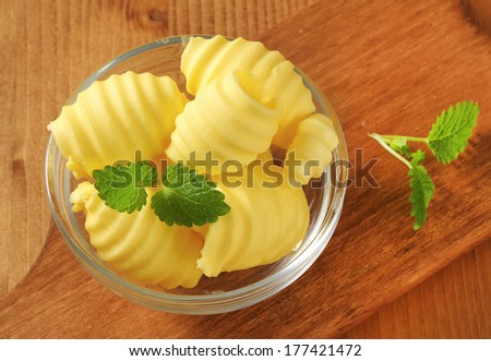 bowl of butter curls on a wooden table