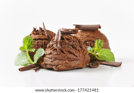 three chocolate ice cream scoop with mint and chocolate curls