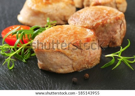 baked juicy pork tenderloin served with fresh tomatoes and herbs