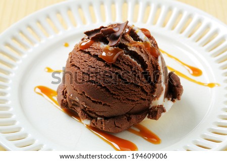 Ice cream scoop decorated caramel and chocolate curls