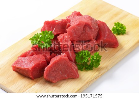 diced beef shoulder on the wooden cutting board
