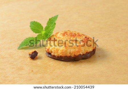 coconut cookies dipped in chocolate, decorated with piece of mint