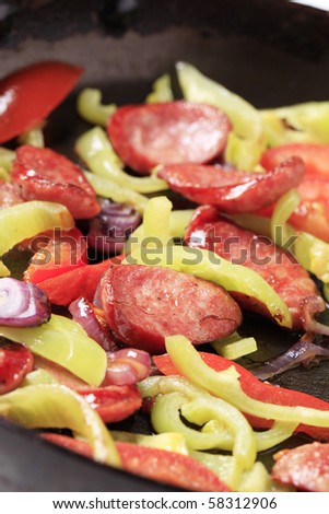Preparing sausage and vegetable stir fry