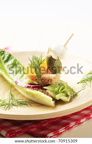 Cold bite-sized vegetarian appetizer on lettuce leaf