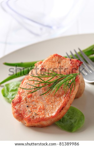 Marinated pork chop garnished with vegetables
