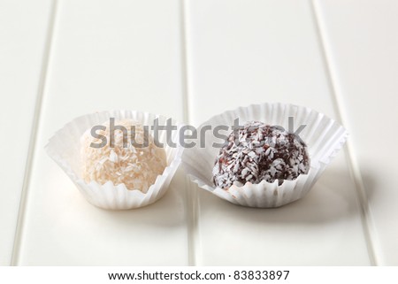 Coconut-coated chocolate balls in paper cups