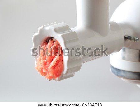 Fresh minced meat coming out of a meat grinder