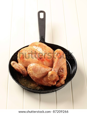 Baked chicken on an iron skillet - studio