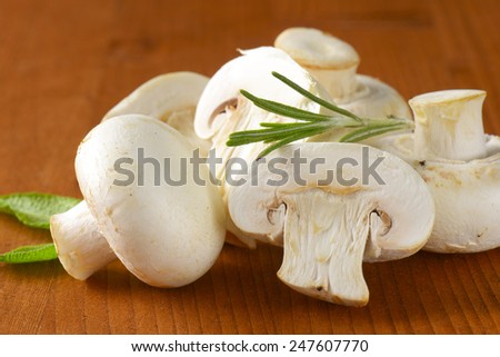 detail of white mushrooms on the wooden background