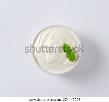 overhead view of fresh sour cream served in the bowl
