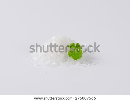 heap of crystal sea salt with parsley
