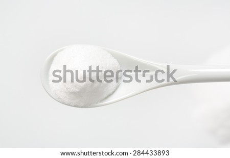 spoon of cooking soda on white background