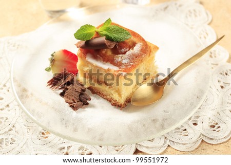 Brioche with chocolate curls and strawberry