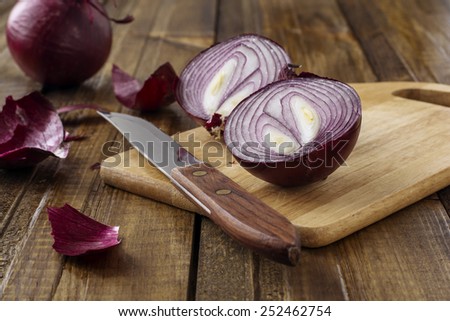 Red onion on wooden background.Selective focus.