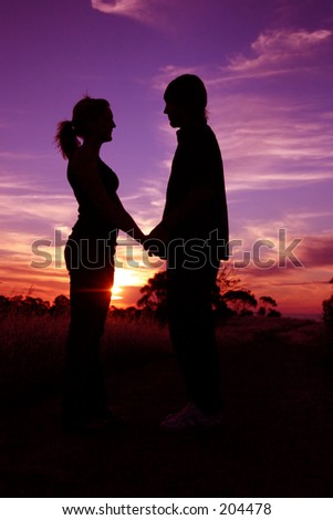 stock photo : couple holding hands at sunset