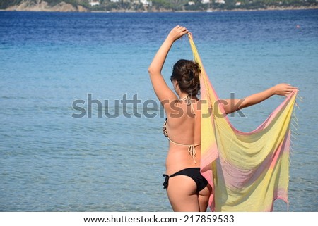 Beautiful Girl With Yellow Scarf on The Beach. Travel and Vacation. Freedom Concept