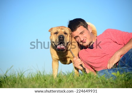 Man with dog outdoors.