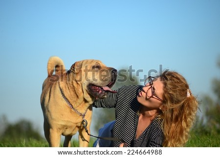 Woman with dog outdoors.