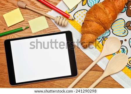 Digital recipe on tablet at kitchen to prepare the breakfast. Top view.