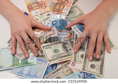 women\'s hands are covered banknotes of the Euro and the dollar