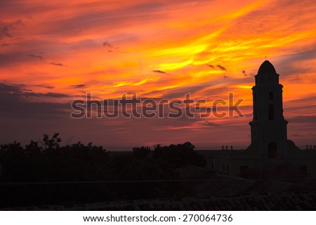 Orange, yellow, pink and red sunset. Rooftop view over Trinidad, Cuba