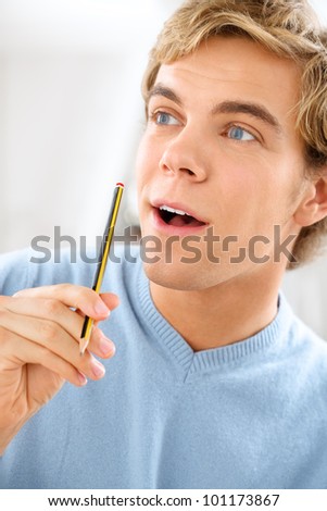 Attractive male university student holing pencil planning ahead