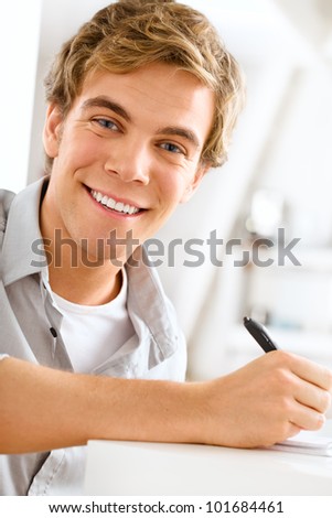 young male professional student is motivated studying at home