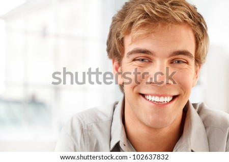 happy male student smiling indoors