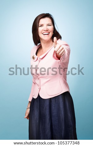 senior mature woman giving thumbs up sign success