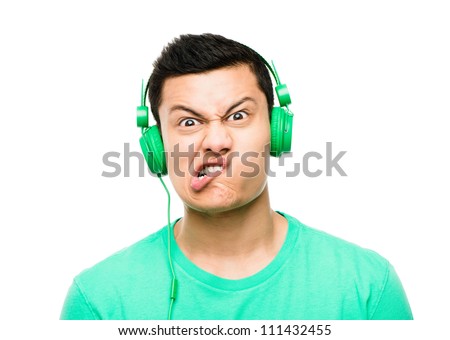 High resolution portrait crazy asian man pulling funny faces wearing headphones isolated on clean white background