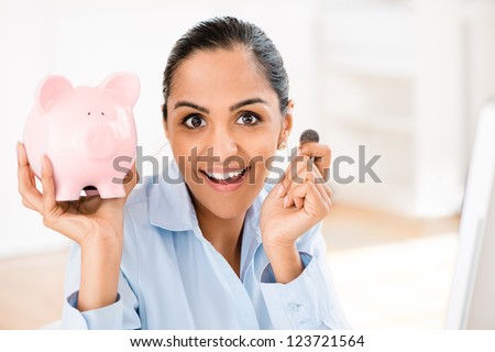 Indian business woman saving money piggy bank