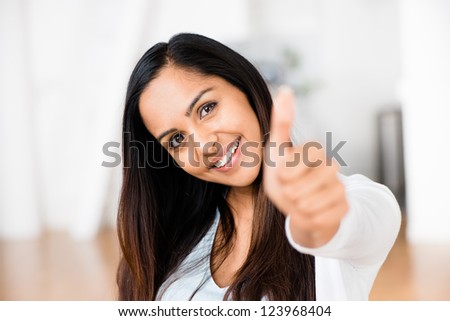 Beautiful Indian woman thumbs up happy smiling