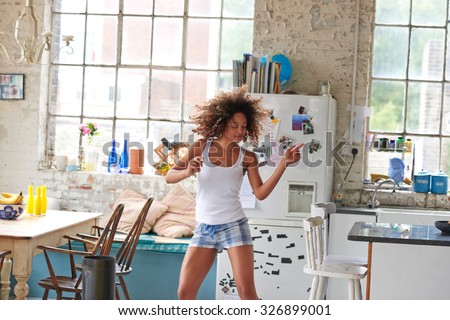 Sexy brazilian girl dancing at home wearing checked pajamas shorts throwing hair back