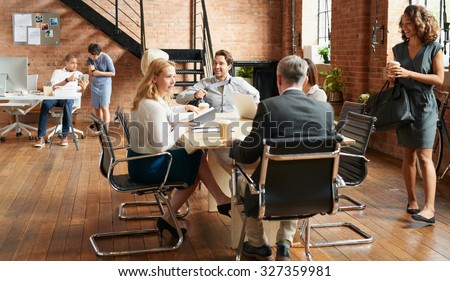 Exciting boardroom meeting with business people in trendy office space